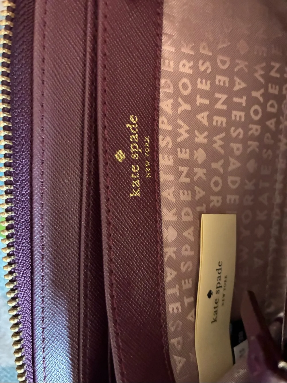 kate spade plum/burgundy zip-around card wallet with gold logo